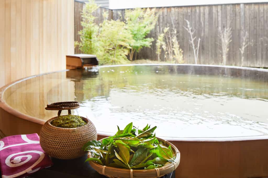 Japanese onsen hot spring bath with tea leaves at hoshino resorts kai enshu in Japan