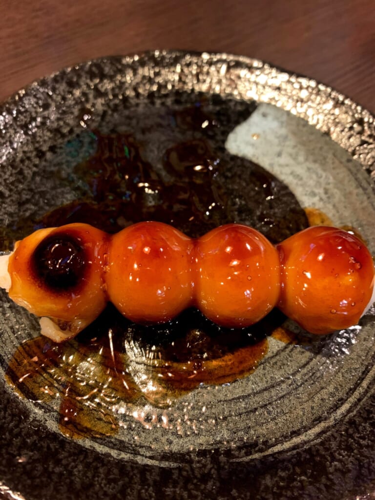 Traditional Japanese dessert of skewered rice flour balls glazed with soy sauce