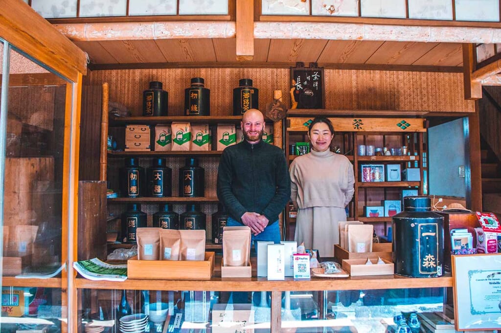 French-Japanese couple standing in their shop in Japan