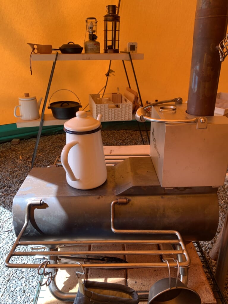 kettle on a stove inside a tent in Japan