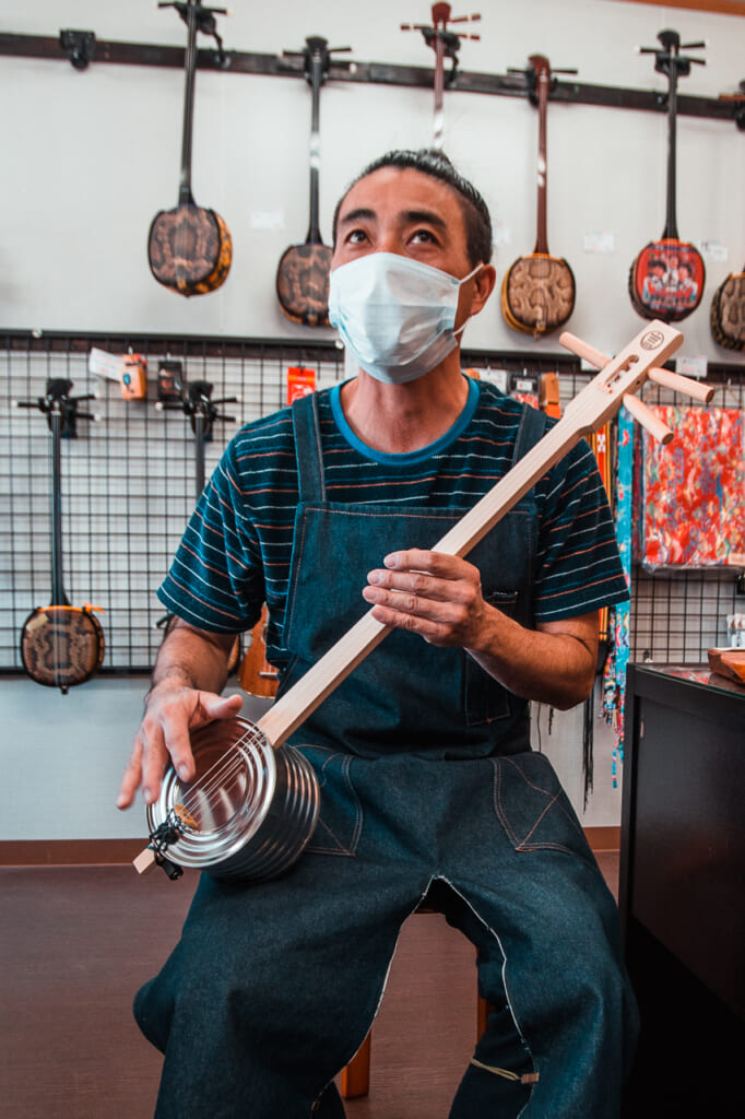 machida-san with a kankara sanshin, traditional japanese instrument