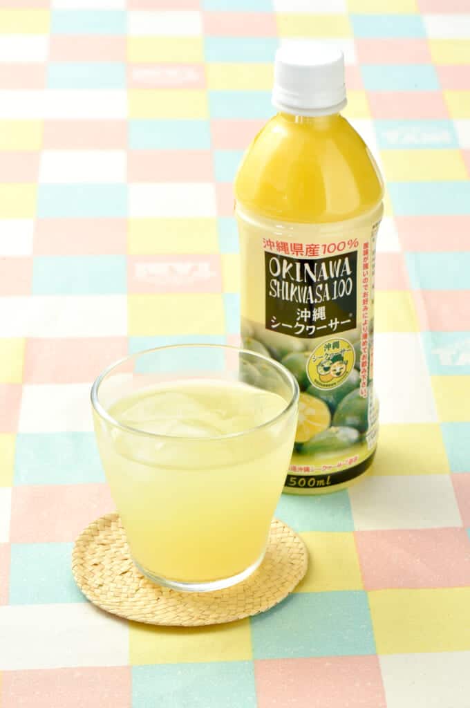 a glass and bottle of shikwasa juice, a citrus fruit