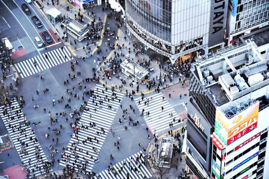 aerial view of pedestrians crossing a large city intersection in Japan