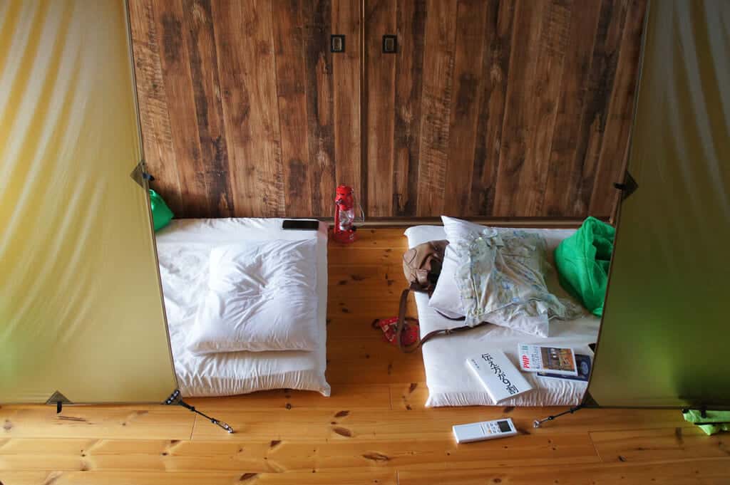 Inside a dormitory with futon mattresses on Manabeshima, a cat island in Japan