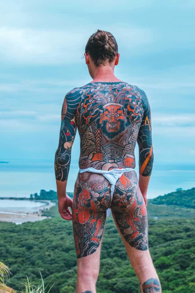 man with full back Japanese tattoo