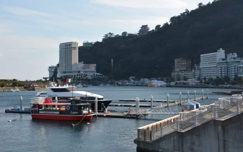 Harbor area of Atami with castle in the background in Japan
