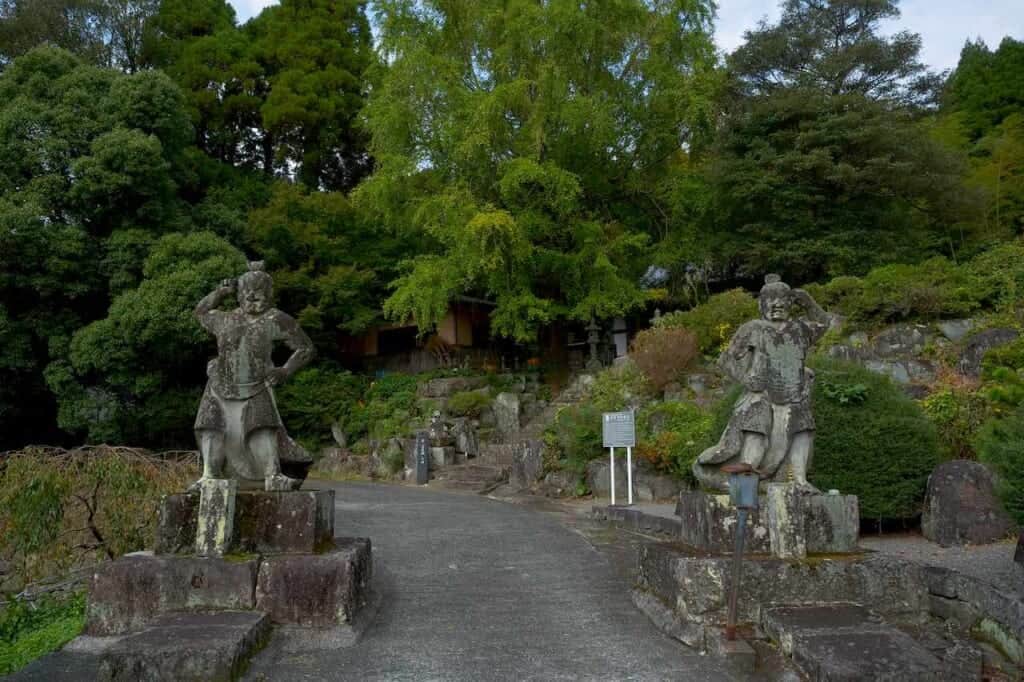 Ancient Japanese stone guardians at entrance to Unganzenji in Japan