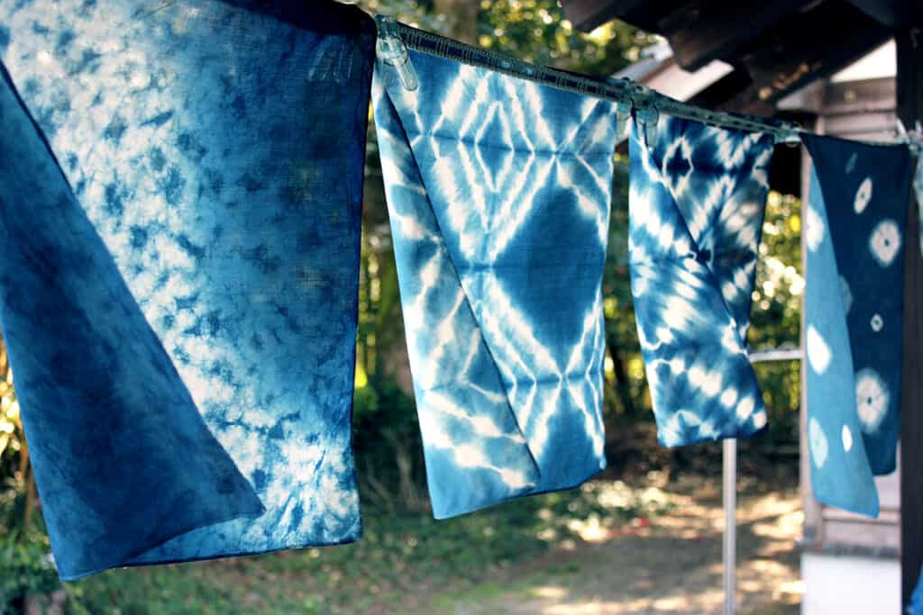 Indigo-dyed scarves drying outside of the Craft Center in Japan