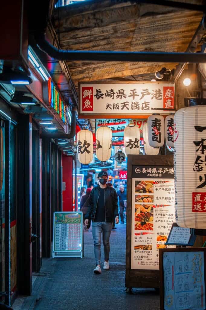 man walking in a street in tenma