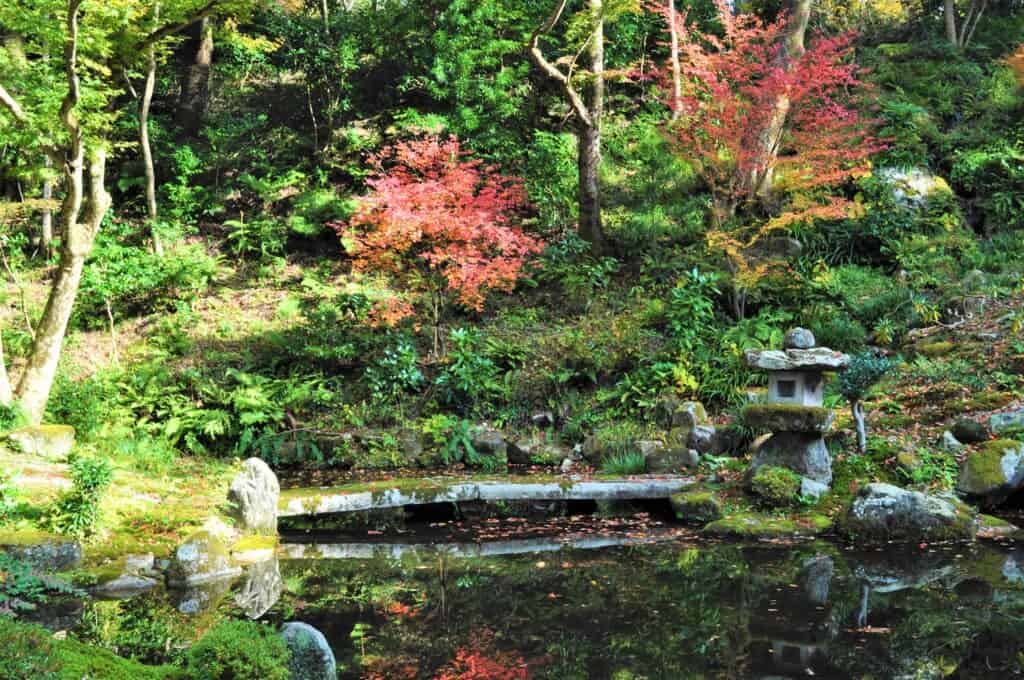 Japanese stone bridge over pond  in Kyoto, Japan