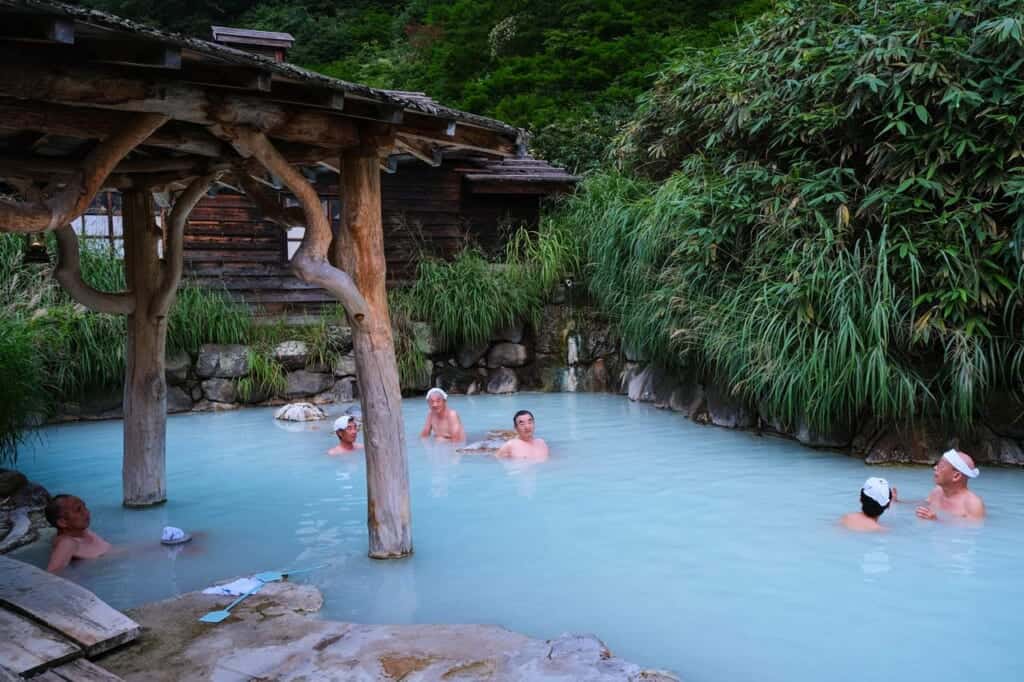 Japanese people bathing in an open-air onsen at Tsurunoyu, Nyuto Onsen