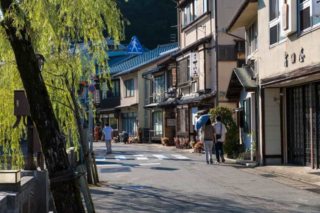 people walking down retro Japanese street in Kinosaki