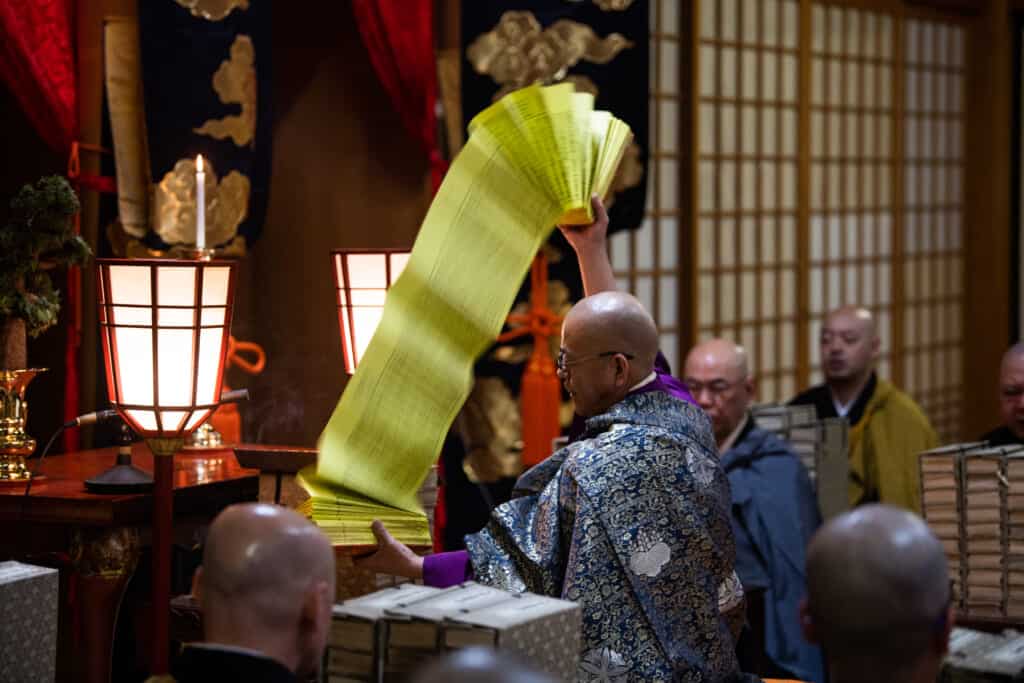 monk performing ritual in Japanese temple