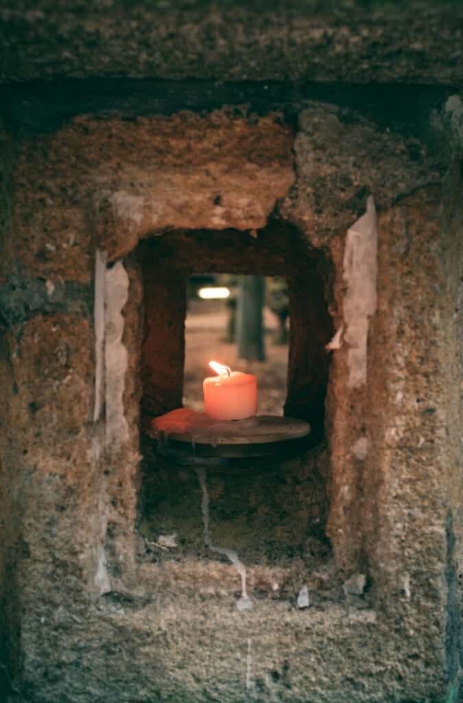 a candle in an old stone lantern in Japan