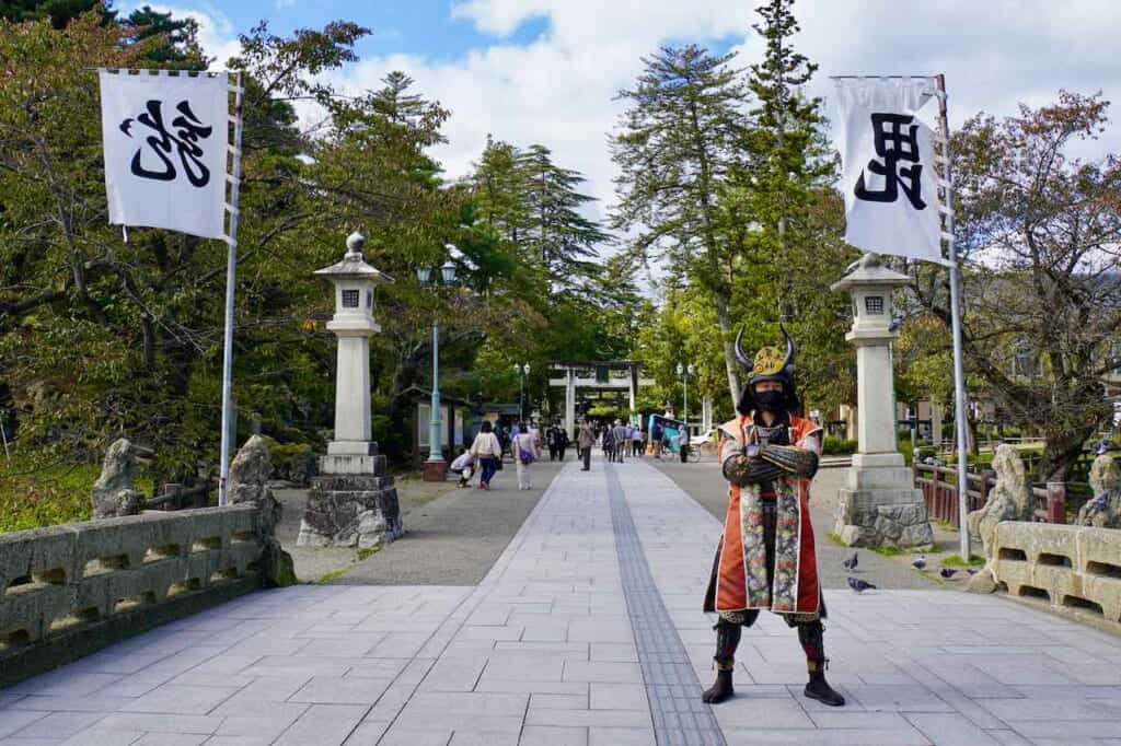 man posing in Japanese samurai outfit in Japan