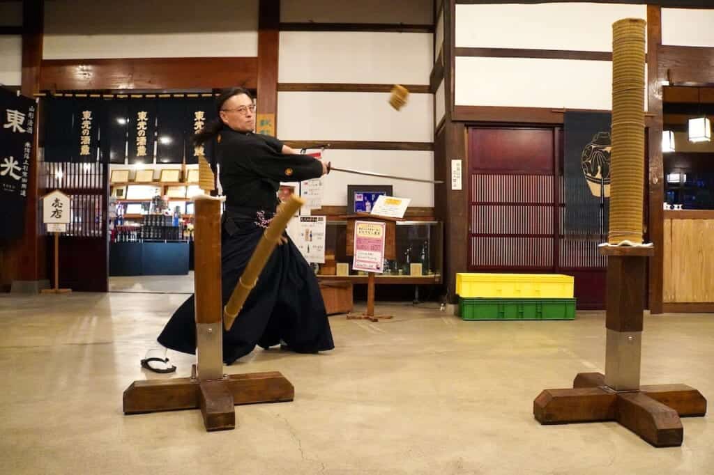 sword master cutting through tatami mats in Iaido demonstration 