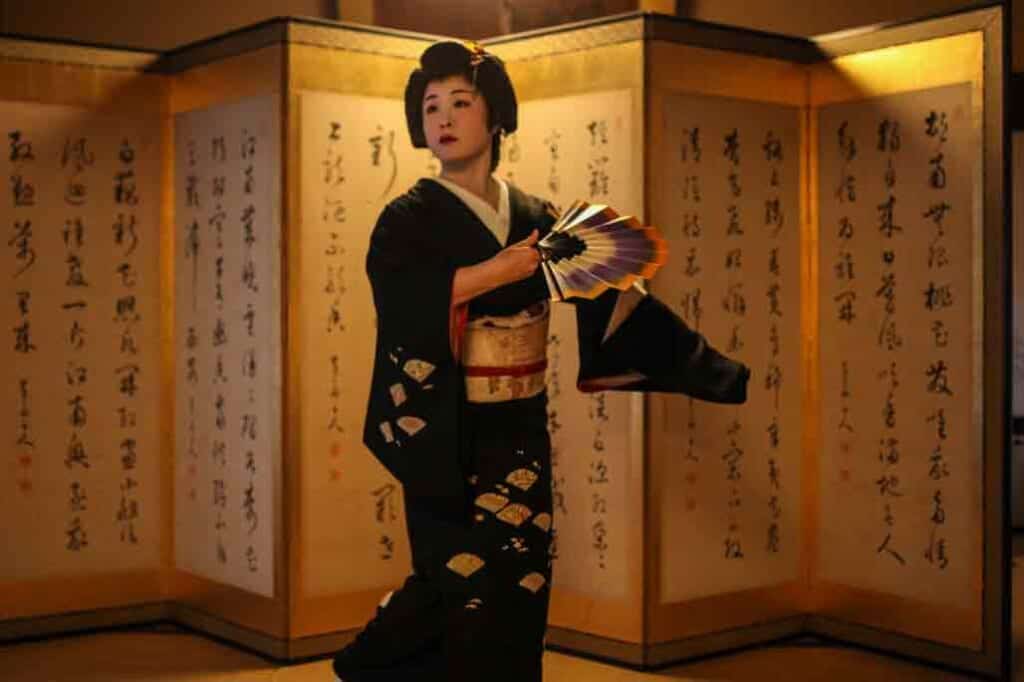 Geisha holding a fan in Japan