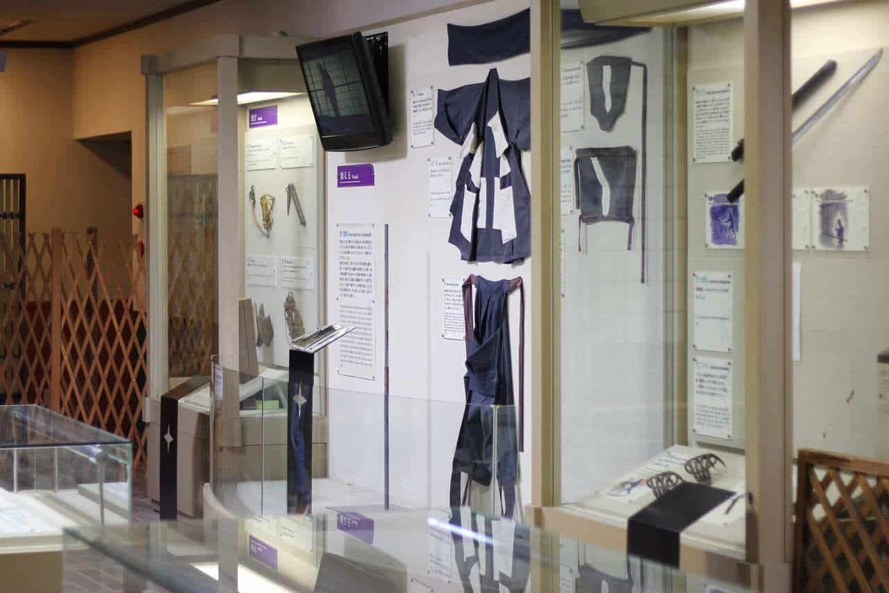 Display cases protect a collection of ninja clothing in a museum, Japan