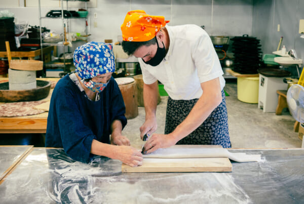 man and woman making soba noodles in Japan