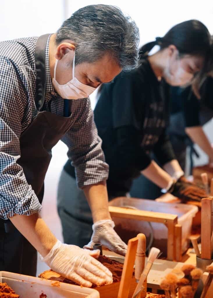 people in tin making workshop in japan