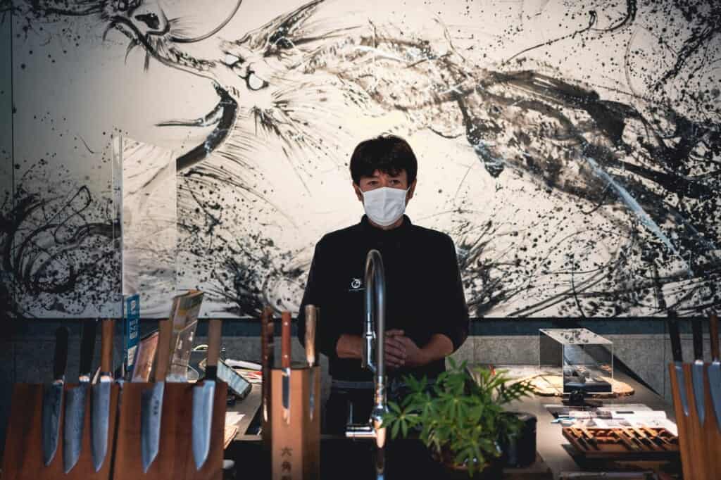 man  in knife showroom in japan
