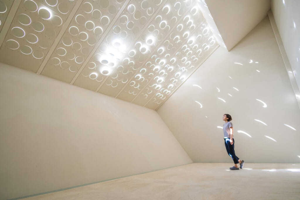 woman  in interactive light and sound art museum in Nagasakibana, Oita, Japan