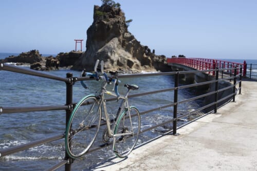 Cycling in Japan while you visit a torii in the sea