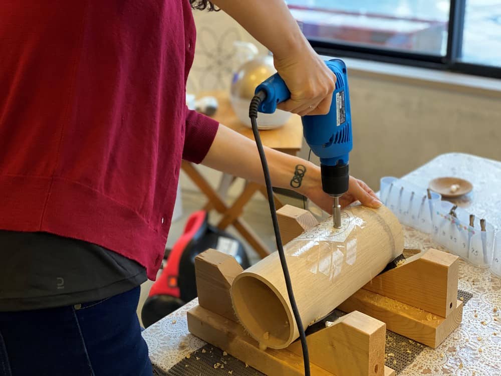 drilling holes into bamboo lanterns