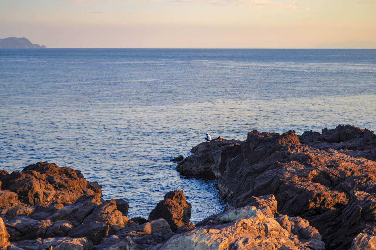 Fishing man next to the coast