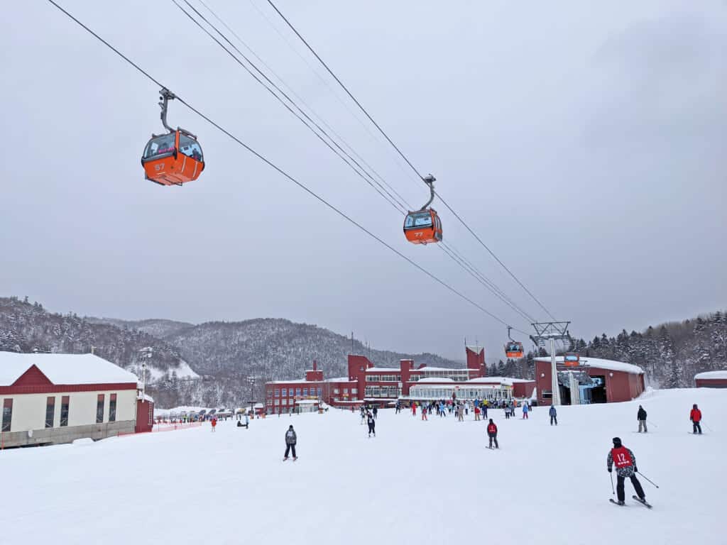 Gondolas and skiers at Sapporo Kokusai Ski Resort