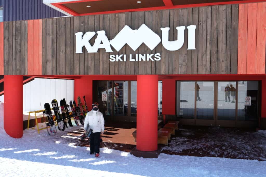 Skier in front of rental office at Kamui ski links

