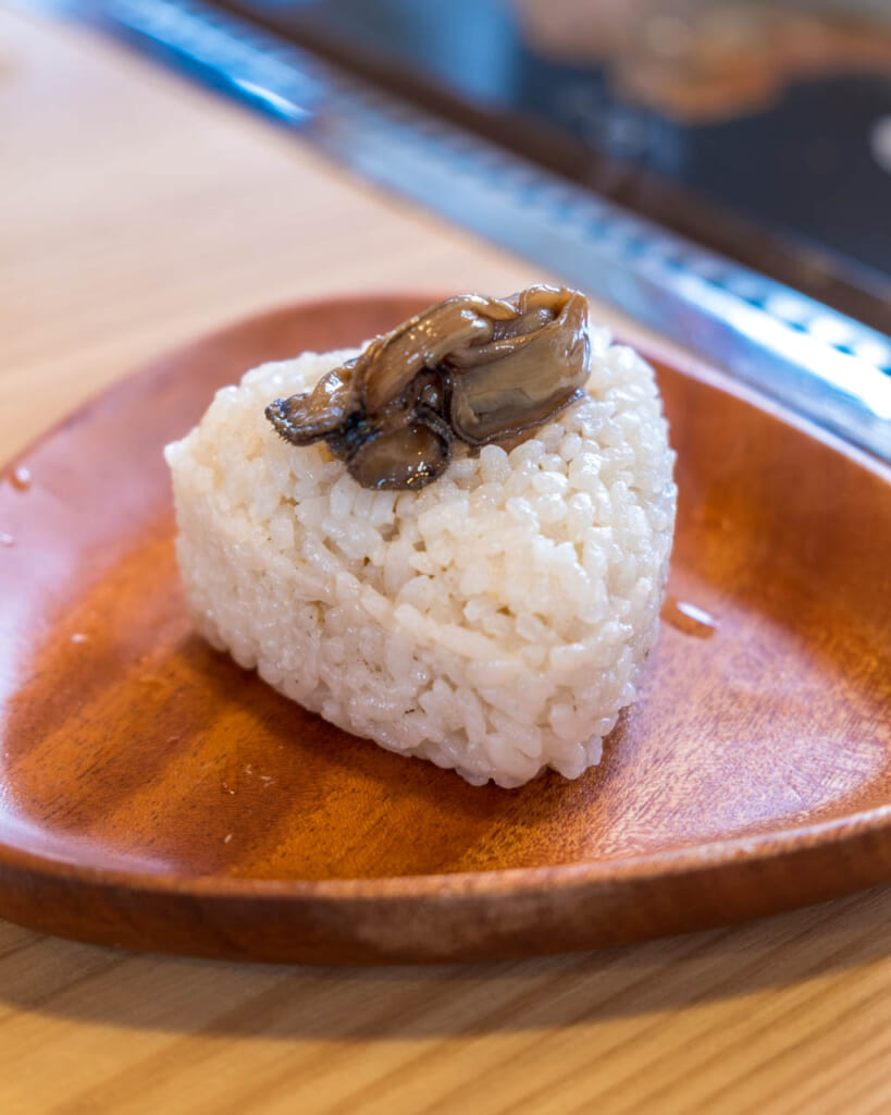oyster on top of onigiri rice ball in japan