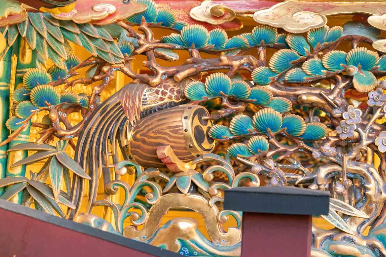 wood carving and gold details on Japanese shrine gate