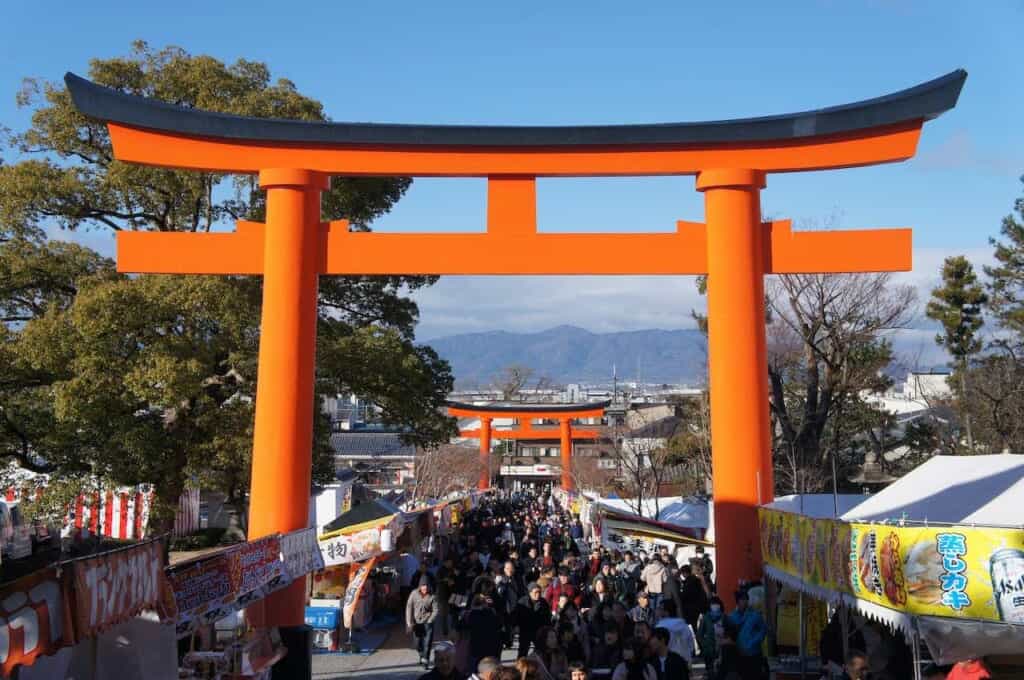 A crowd walking under torii gates during the New Year's national holidays in Japan