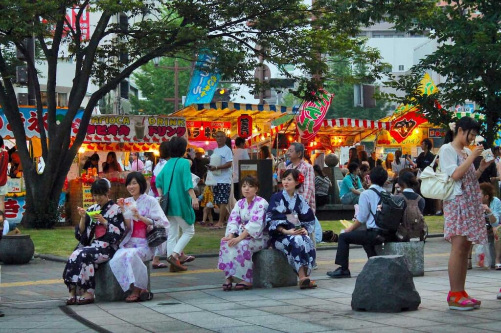 People wearing yukata at a summer matsuri in Japan