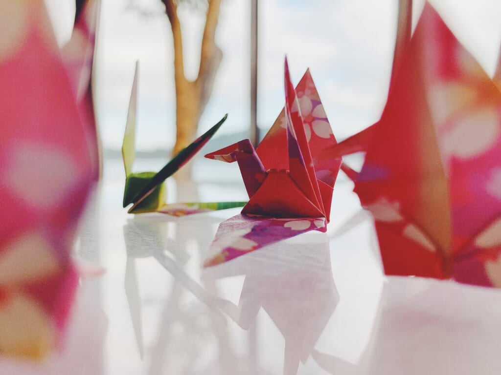 several Crane Origami on a table