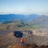 Man looking over large volcano crater in Mount Aso in Japan
