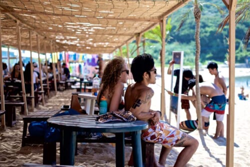 A Japanese boy with tattoos in the beach