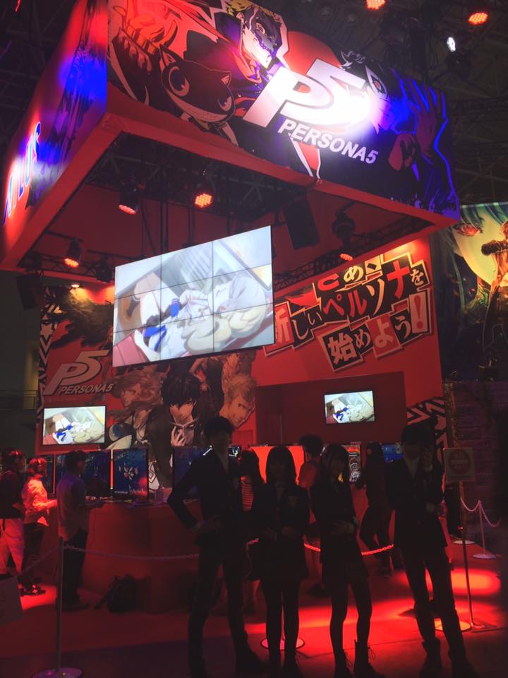 People standing at Tokyo game show booth in Japan