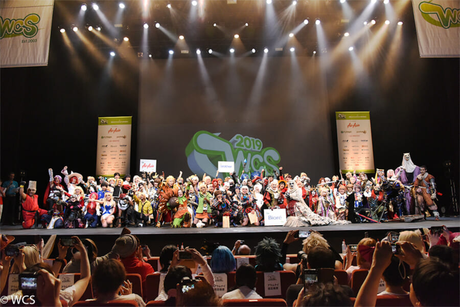 Finalists at the world cosplay summit posing on a big stage in Tokyo, Japan