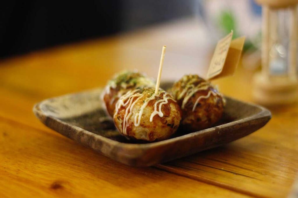 three takoyaki balls on plate