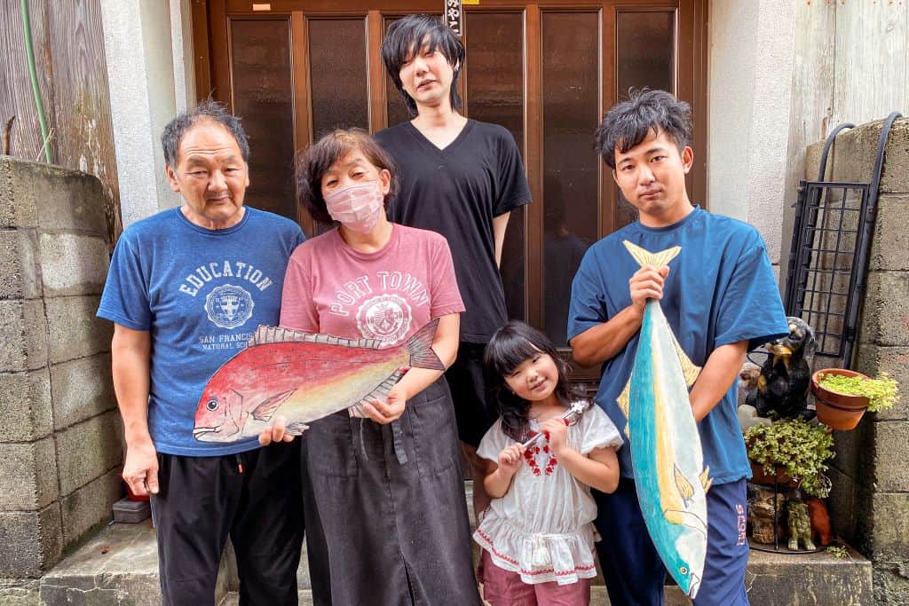 Yamashita family poses in front of Minshuku Miyako