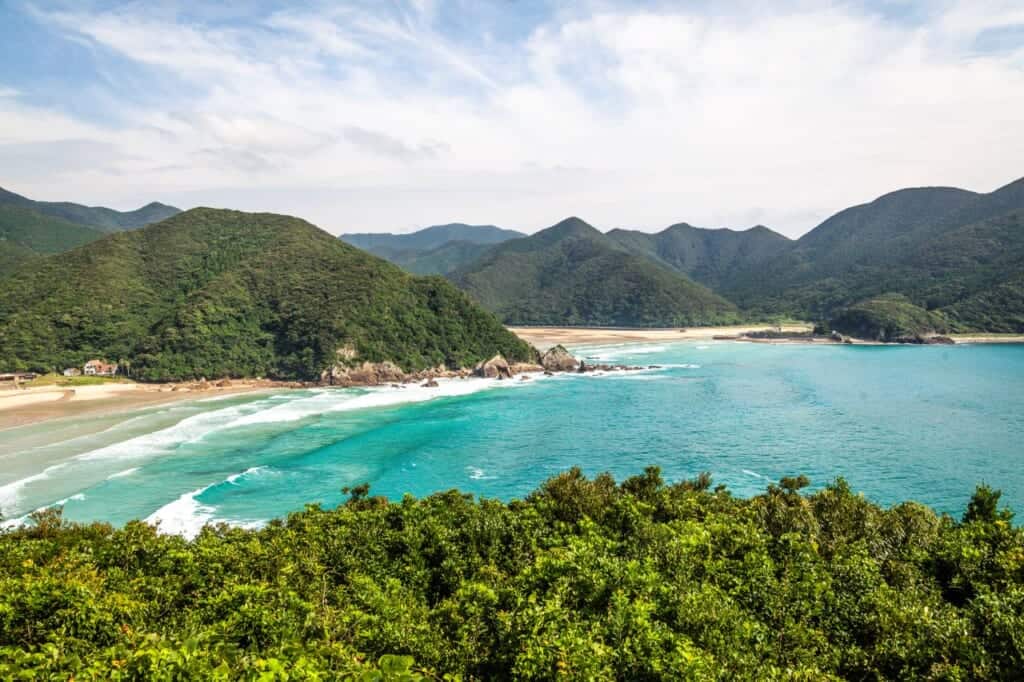 turquoise blue waters and mountains at Takahama Beach