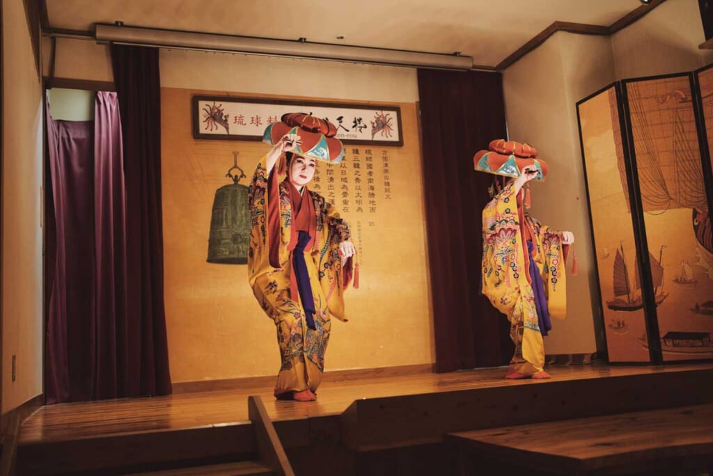 traditional Okinawa dance performance by two performers wearing traditional clothing