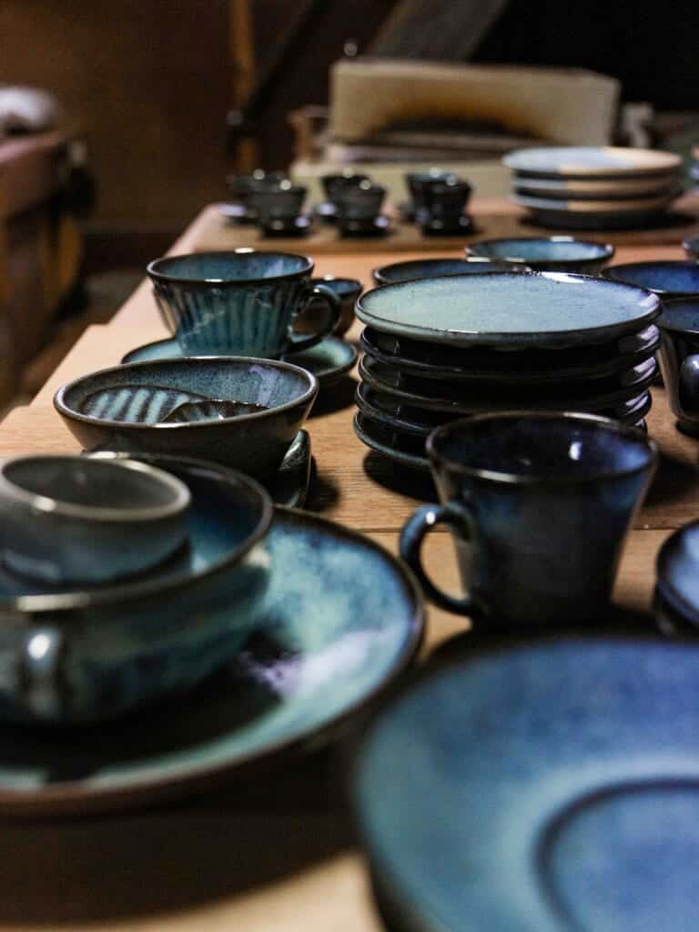 various blue glazed plates, bowls and mugs