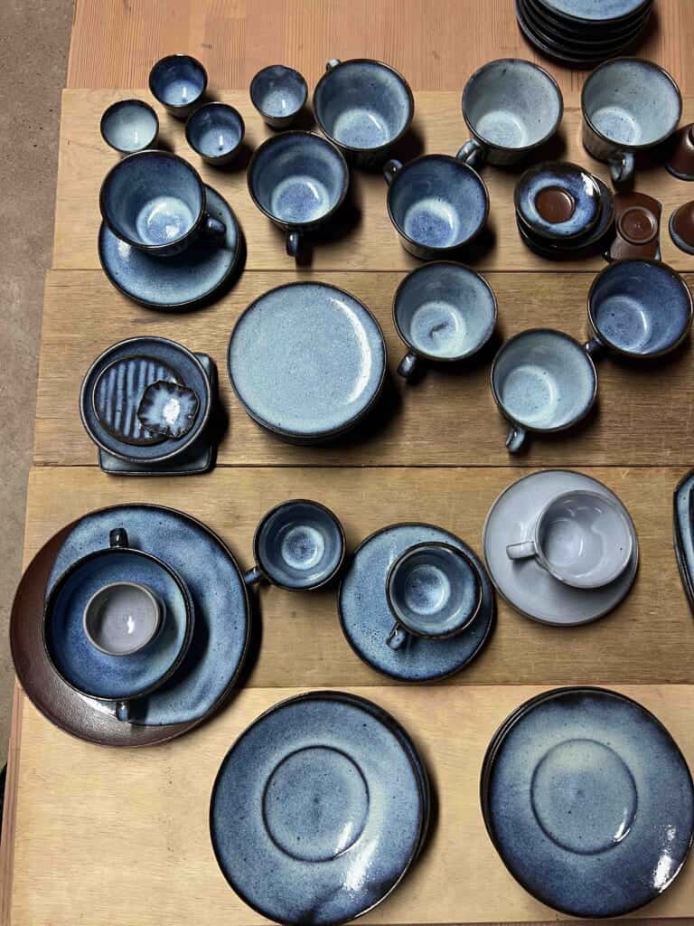 various blue glazed bowls, mugs, and plates