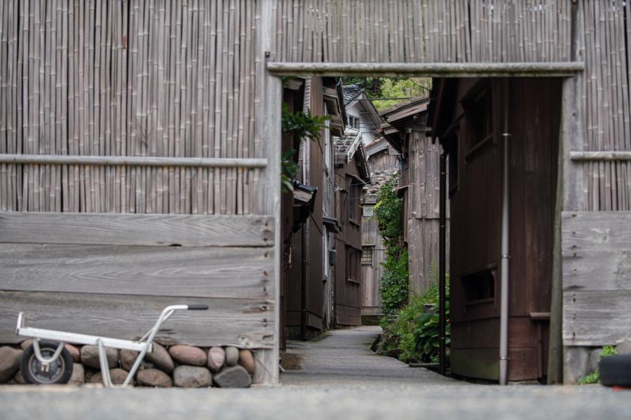 National street view with wooden houses down narrow alleyway on Sado island, Japan