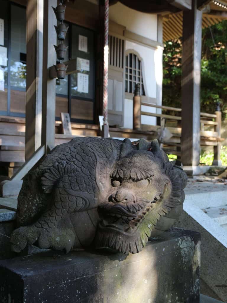 Stone carving of a dragon in front of a Japanese temple