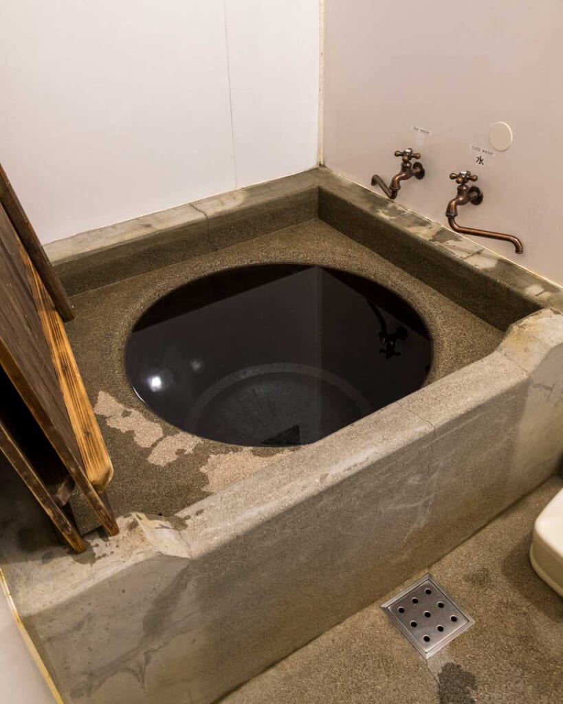 A Goemonburo cauldron bath filled with hot water in Japanese traditional inn, in Kagoshima Japan