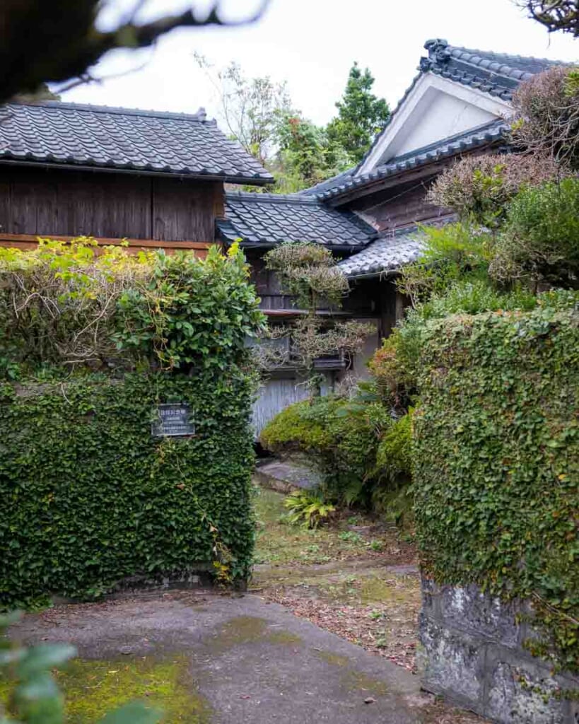 Traditional Japanese samurai house with stone walls covered with greenery in Japan